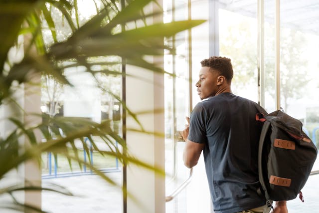 a%20student%20leaving%20a%20building%20wearing%20a%20backpack a%20student%20leaving%20a%20building%20wearing%20a%20backpack